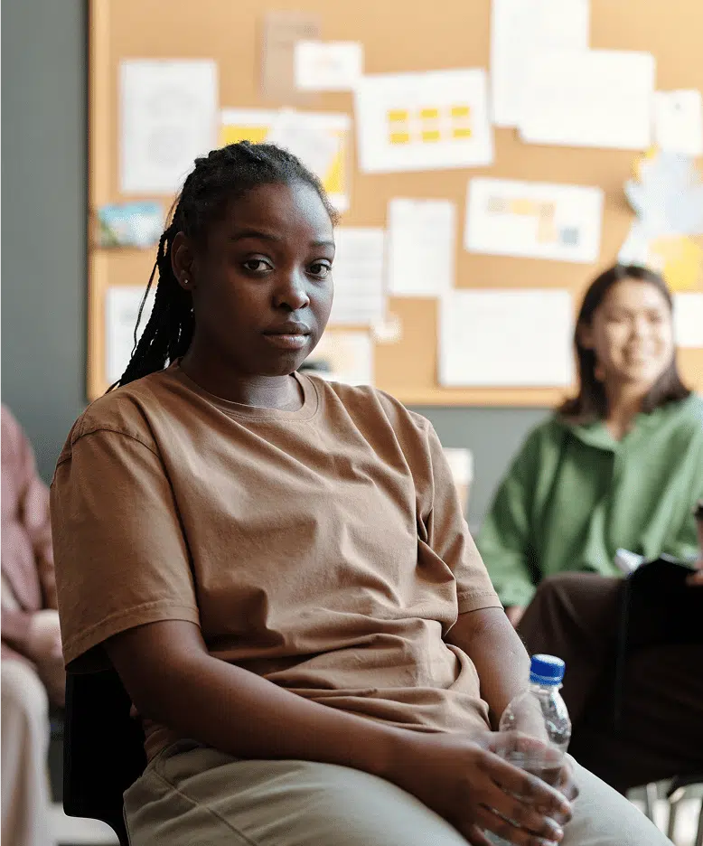Young upset woman with bottle of water