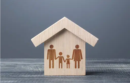 a wooden house with a family printed on it