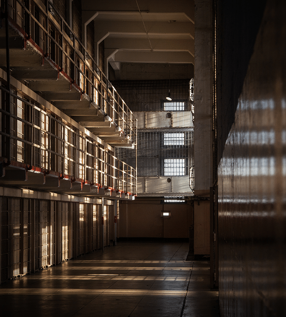 A phot of inside a Juvenile Detention Center, there are no children, just a view of empty cells